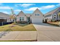Inviting home with a well-manicured lawn, stone accents, and a two-car garage in a friendly neighborhood at 127 Laurel Farms Ln, Dallas, GA 30157