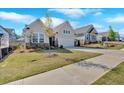 Beautifully landscaped home with a two-car garage, stone accents, and a lush green lawn at 127 Laurel Farms Ln, Dallas, GA 30157