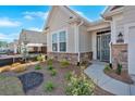 Charming home featuring a stone facade, manicured landscaping, and a welcoming front entrance at 127 Laurel Farms Ln, Dallas, GA 30157