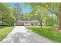 Charming home featuring a two-car carport and beautiful, mature trees in the yard at 1391 Arden Sw Dr, Marietta, GA 30008