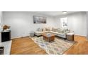 Spacious living room featuring hardwood floors and comfortable neutral-toned furnishings at 113 Courtyard Ter, Roswell, GA 30075