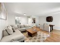 Open-concept living and dining area with hardwood floors and ample seating at 113 Courtyard Ter, Roswell, GA 30075