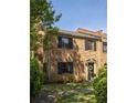 A brick townhome with black shutters, well-kept lawn and manicured landscaping at 266 Adair St, Decatur, GA 30030