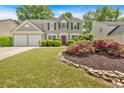 Beautiful home with manicured lawn, stone-lined flower beds, and colorful shrubs at 3463 Chastain Glen Ne Ln, Marietta, GA 30066