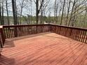 Spacious wooden deck with railings, perfect for outdoor entertaining and relaxing with a nice wooden fence at 602 Springharbor Dr, Woodstock, GA 30188
