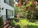 Beautiful backyard featuring a lush lawn, garden, and mature trees providing shade and privacy at 602 Springharbor Dr, Woodstock, GA 30188