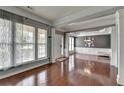 Elegant living room with hardwood floors, decorative columns, and ample natural light at 4280 Azurite St, Cumming, GA 30040