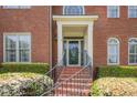 Elegant front entrance with brick steps, decorative door and manicured landscaping at 1655 Holly Lake Cir, Snellville, GA 30078