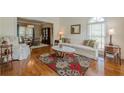 Bright living room with hardwood floors, large windows, and stylish furniture at 1655 Holly Lake Cir, Snellville, GA 30078