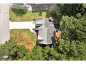 Aerial view of a well-maintained home with a spacious backyard surrounded by mature trees at 2875 Riverbend Ct, Snellville, GA 30078