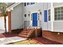 Inviting front entrance with brick steps and a bright blue door at 2875 Riverbend Ct, Snellville, GA 30078
