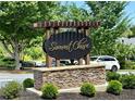 The community sign reads: Summit Chase, set amidst lush greenery at 2875 Riverbend Ct, Snellville, GA 30078