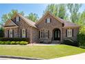 Charming brick home boasts a manicured lawn, beautiful landscaping, and inviting curb appeal at 3053 Lawson Dr, Marietta, GA 30064