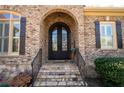 Arched, double front door, brick facade, and stone steps add character to this home's entrance at 3053 Lawson Dr, Marietta, GA 30064