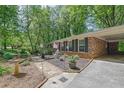 Brick house featuring a covered carport and landscaped front garden at 3139 Mary Dr, Marietta, GA 30066