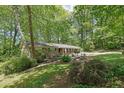 Charming brick home nestled on a wooded lot with a beautiful, landscaped front yard and flower beds at 3139 Mary Dr, Marietta, GA 30066