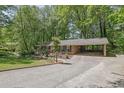 Traditional brick home with a convenient carport and well-manicured lawn in a serene, wooded setting at 3139 Mary Dr, Marietta, GA 30066