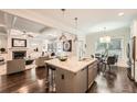 Open-concept kitchen with a large island, stainless appliances, and seamless flow to the living room at 3699 School Street, Chamblee, GA 30341