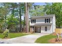 Charming two-story home with stone accents, black shutters and a well-maintained front yard at 6891 Hickory Log Rd, Austell, GA 30168