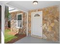 Close-up of the front porch with stone details and a classic white front door at 6891 Hickory Log Rd, Austell, GA 30168