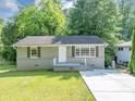 Charming home featuring a well-maintained lawn, gray painted brick foundation and concrete driveway at 1677 Wayland Ne Cir, Brookhaven, GA 30319