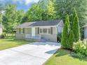 Charming home featuring a well-maintained lawn, gray painted brick foundation and concrete driveway at 1677 Wayland Ne Cir, Brookhaven, GA 30319