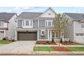 Charming home featuring a well-manicured lawn, a spacious garage, and a welcoming exterior at 3003 Clayton St, Woodstock, GA 30188