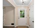 Bright entryway featuring hardwood floors, white trim and a view to the outdoors from a glass-paneled door at 4628 Mountain Creek Ne Dr, Roswell, GA 30075