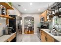 Modern kitchen featuring stainless steel appliances, light wood cabinetry, open shelving, and access to the dining room at 67 Lannon Ne Ave, Atlanta, GA 30317