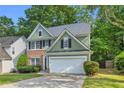Charming two-story home with a well-manicured lawn and a two-car garage at 335 Pintail Ct, Suwanee, GA 30024