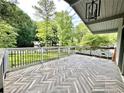 Spacious outdoor deck with unique chevron-patterned flooring and black metal railings, perfect for entertaining at 4882 Rock Haven Sw Dr, Lilburn, GA 30047