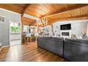 Inviting living room boasts hardwood floors, vaulted wood ceilings, a cozy fireplace, and ample natural light at 4882 Rock Haven Sw Dr, Lilburn, GA 30047