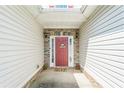 Close-up of a welcoming front door, showcasing stone accents and decorative wreath at 152 Ridge Xing, Temple, GA 30179
