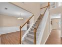 Bright and spacious foyer with a staircase leading to the second floor and hardwood floors at 362 Interlake Pass, Mcdonough, GA 30252