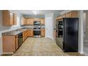 Spacious kitchen featuring stainless steel appliances and wooden cabinetry at 4139 Kensington Cv, Atlanta, GA 30349