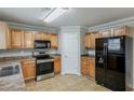 Bright kitchen with wooden cabinets and stainless steel appliances at 4139 Kensington Cv, Atlanta, GA 30349