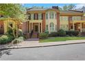 Charming brick townhome with well-maintained landscaping and inviting front entrance at 1020 Riverside Rd, Roswell, GA 30076