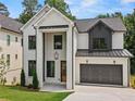 Charming new construction home featuring painted brick, black accents, and a two-car garage at 267 Green Hill Rd, Sandy Springs, GA 30042
