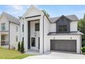 Beautiful new construction home with white painted brick, black accents, and a covered entryway at 267 Green Hill Rd, Sandy Springs, GA 30042