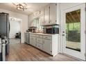 Updated kitchen featuring white cabinets, vinyl floors, and stainless appliances at 408 Walnut Dr, Woodstock, GA 30189