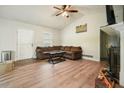 Inviting living room with a vaulted ceiling, cozy seating, fireplace, and stylish hardwood floors at 408 Walnut Dr, Woodstock, GA 30189