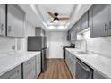 Stylish kitchen with stainless steel appliances, sleek countertops, and ample storage space in gray cabinets at 6851 Roswell Rd # C7, Atlanta, GA 30328
