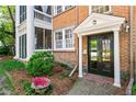 Charming brick home with a black front door and manicured landscaping at 8 Collier Nw Rd # A1, Atlanta, GA 30309