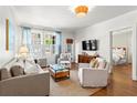 Sunlit living room with hardwood floors, neutral palette, and cozy seating arrangement at 8 Collier Nw Rd # A1, Atlanta, GA 30309