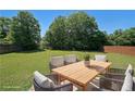 Spacious backyard with a patio set for outdoor relaxation and dining, virtually staged for inspiration at 8449 Kendrick Rd, Jonesboro, GA 30238
