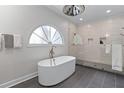 Modern bathroom featuring a standalone tub, glass-enclosed shower, and stylish tile flooring at 1811 Fountain Hill Ct, Duluth, GA 30097