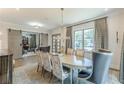 View of a dining room with sliding barn doors, chandelier, hardwood floors, and large windows at 1272 N Highland Ne Ave, Atlanta, GA 30306