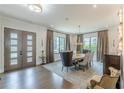 View of a dining room boasting a modern chandelier, many windows, and stylish decor and furniture at 1272 N Highland Ne Ave, Atlanta, GA 30306