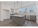 Well-lit kitchen featuring stainless steel appliances, a large island, and white cabinets at 1779 Beckham Ne Pl # 58, Atlanta, GA 30324