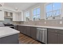 This kitchen has granite countertops, stainless steel appliances, and gray cabinets at 1779 Beckham Ne Pl # 58, Atlanta, GA 30324